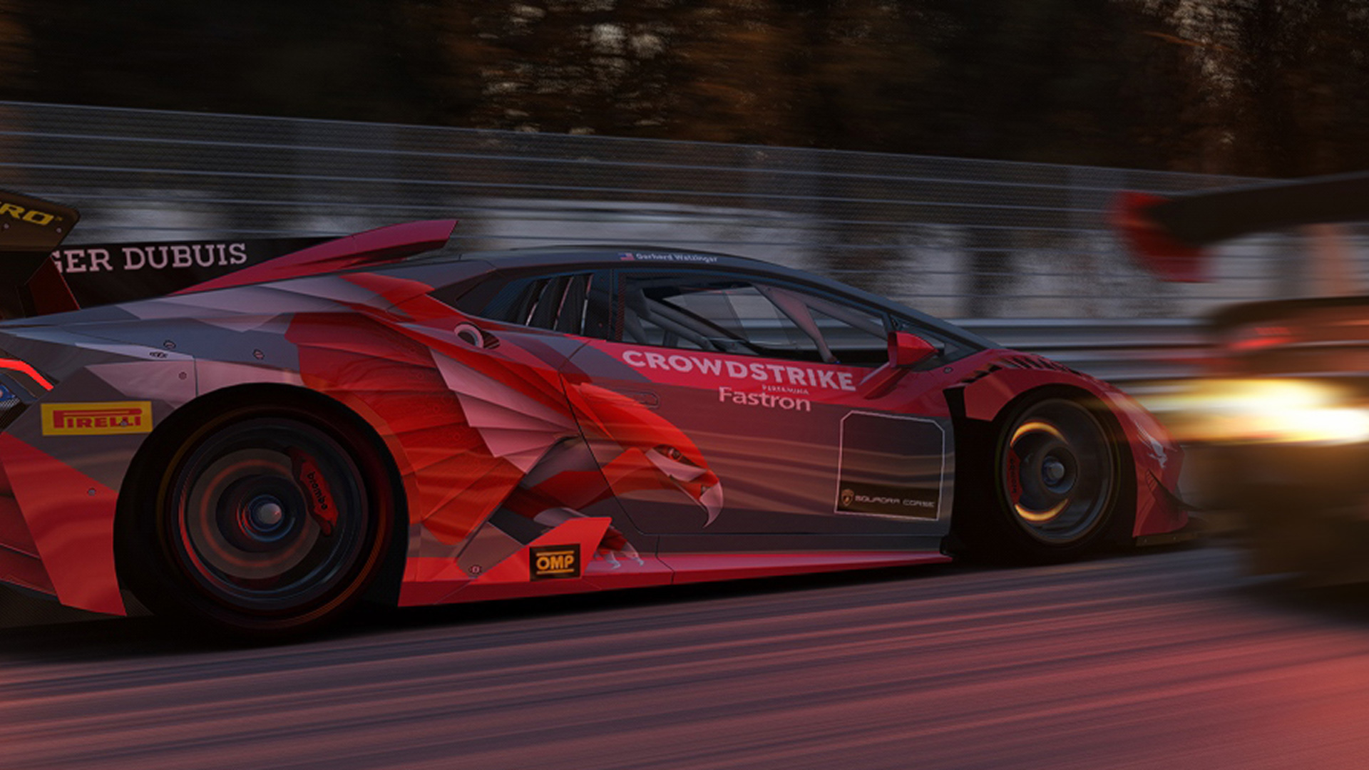 A sponsored racing car speeding around a track, featuring a custom red and grey CrowdStrike livery that prominently displays the brand's mechanical falcon graphic on the side.